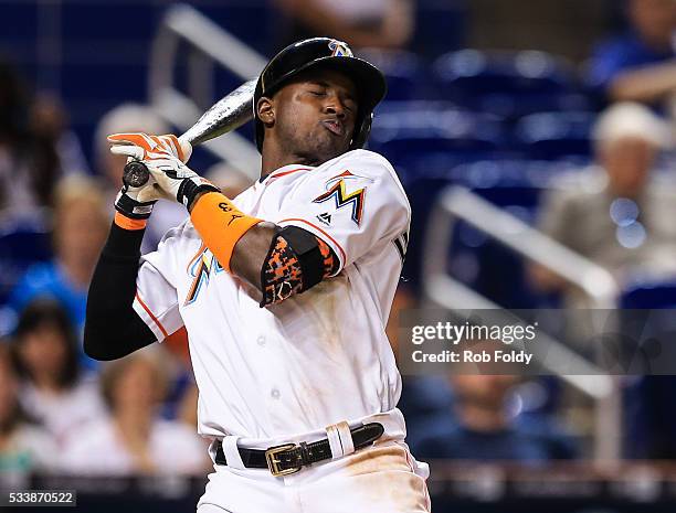 Adeiny Hechavarria of the Miami Marlins reacts to an inside pitch during the eighth inning of the game against the Tampa Bay Rays at Marlins Park on...