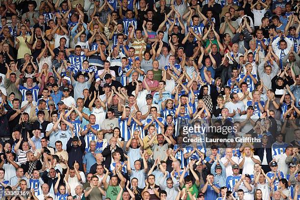 Capacity crowd applauds their players' efforts during the Barclays Premiership match between Wigan Athletic and Chelsea on August 14, 2005 in Wigan,...