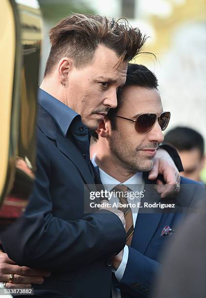 Actors Johnny Depp and Sacha Baron Cohen attend Disneys 'Alice Through the Looking Glass' premiere with the cast of the film, which included Johnny...