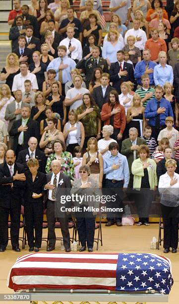 Mourners stand for the National Anthem during Lance Cpl. Timothy Bell Jr.'s memorial service August 14, 2005 in Liberty Township, Ohio. Bell was one...
