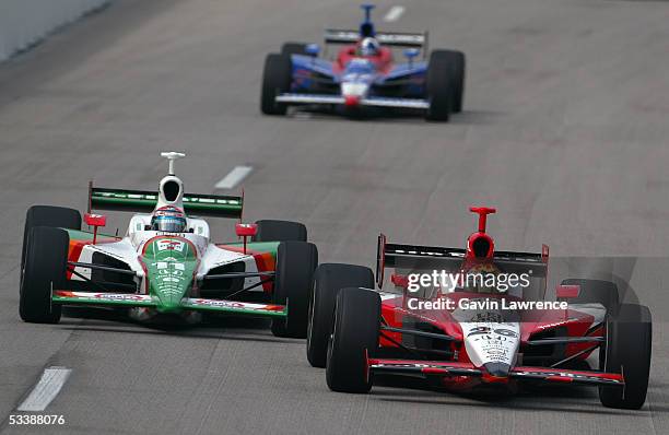 Dan Wheldon, driver of the Klein Tools/Jim Beam Andretti Green Racing Jim Dallara Honda, leads Tony Kanaan, driver of the Team 7-Eleven Andretti...