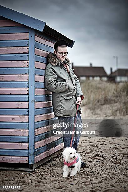 portrait of mid 20's male and his dog leaning - chinese crested powderpuff stock pictures, royalty-free photos & images