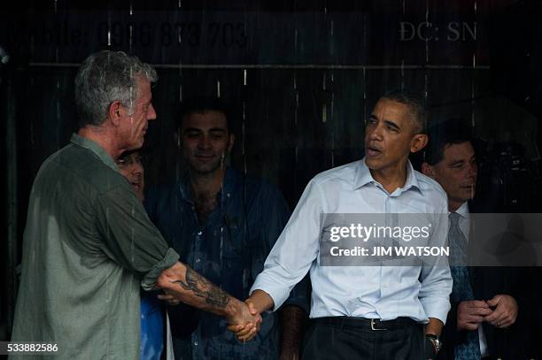 President Barack Obama shakes hands with Anthony Boudain , a chef and food critic who fronts a travel show about hidden culinary gems around the...