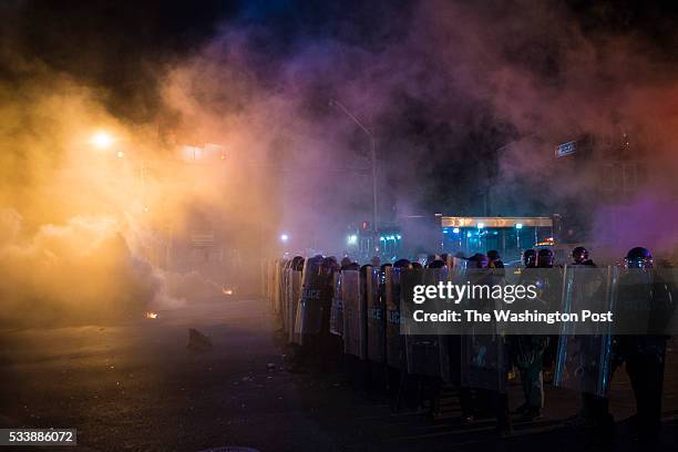 Officers fire tear gas and pepper balls to clear the streets after the 10pm curfew near the intersection of West North Avenue and Pennsylvania Avenue...