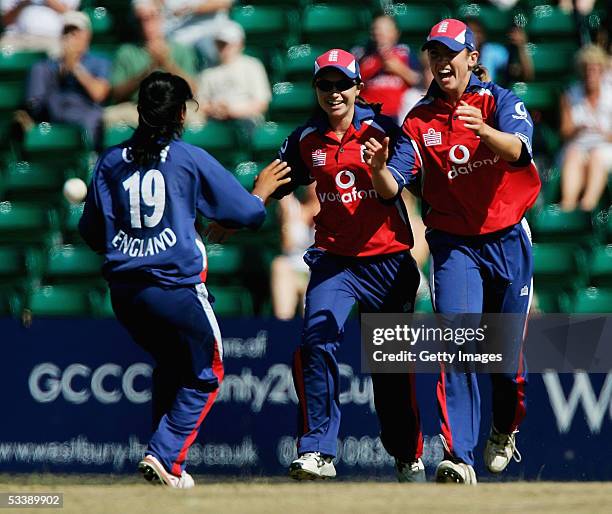 Isa Guha of England runs over to congratulate team mate Beth Morgan on catching out Belinda Clarke of Australia during the One Day International...