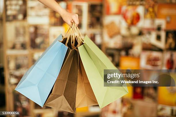 hand holding shopping bags - grocery bag stock pictures, royalty-free photos & images