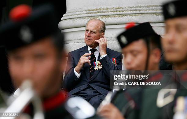 London, UNITED KINGDOM: Prince Phillip the Duke of Edinburgh, who served with the British Pacific Fleet listens to the Band of the Brigade of Gurkhas...