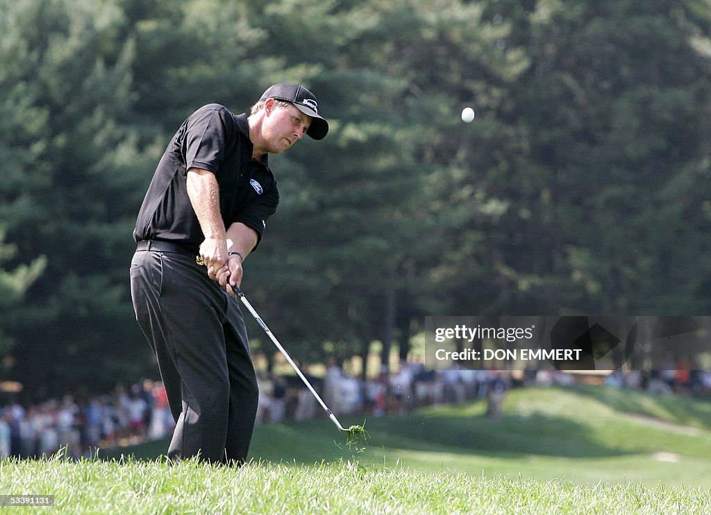 Phil Mickelson of the US chips onto the