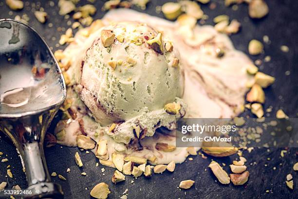 delicious pistachio ice cream on a background - pistachio ice cream stock pictures, royalty-free photos & images