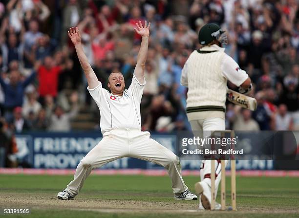 Andrew Flintoff of England celebrates taking the wicket of Shane Warne of Australia during day five of the third npower Ashes Test match between...
