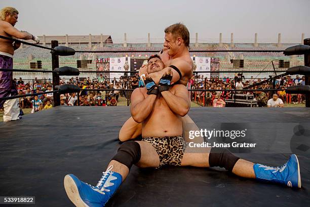 The Nepalese wrestler "Nuwakot Tiger" fighting with his opponent from New Zealand in the ring.The first international wrestling competition was held...