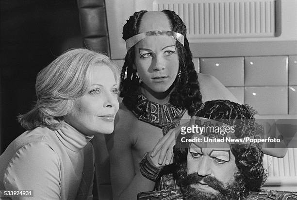 Actors Barbara Bain, Michael Gallagher and John Standing pictured together dressed in character on set during filming of the science fiction...