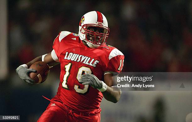 Running back Michael Bush of the Louisville Cardinals runs upfield against the Boise State Broncos during the AutoZone Liberty bowl at the Liberty...