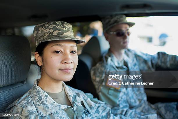 army woman and man in car - army soldier portrait stock pictures, royalty-free photos & images