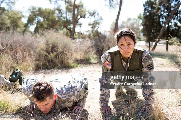 army woman and man doing pushups - army woman stock pictures, royalty-free photos & images