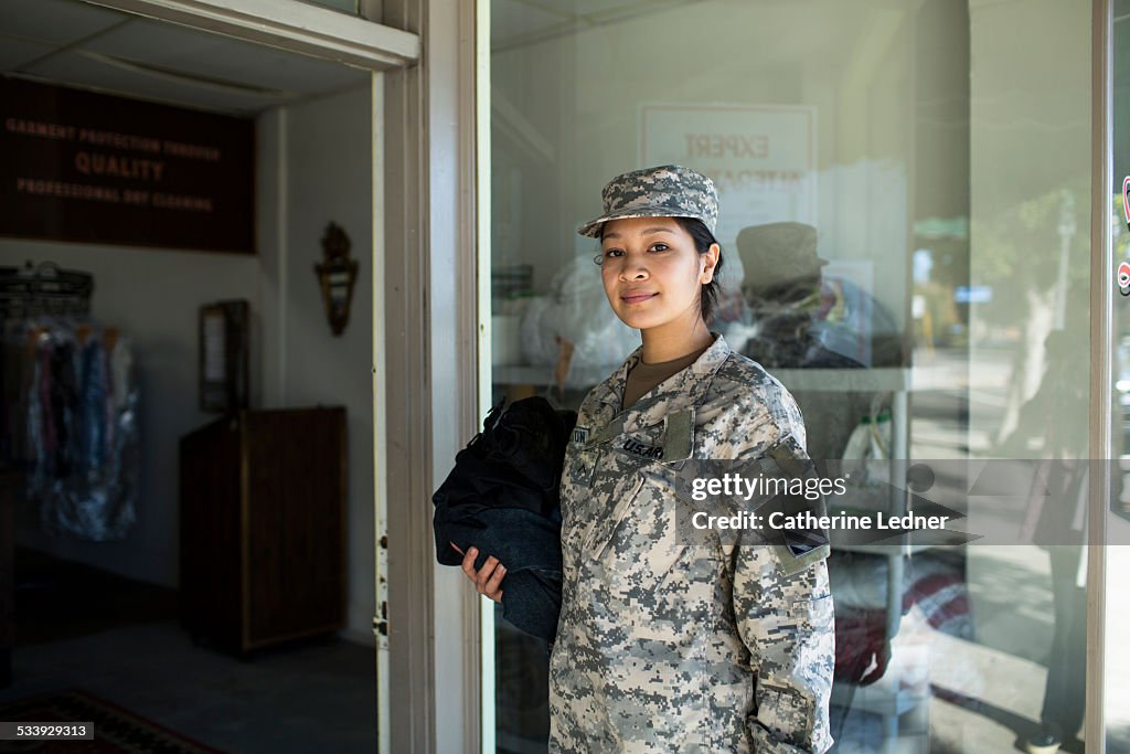 Army Woman bringing laudry to dry cleaners