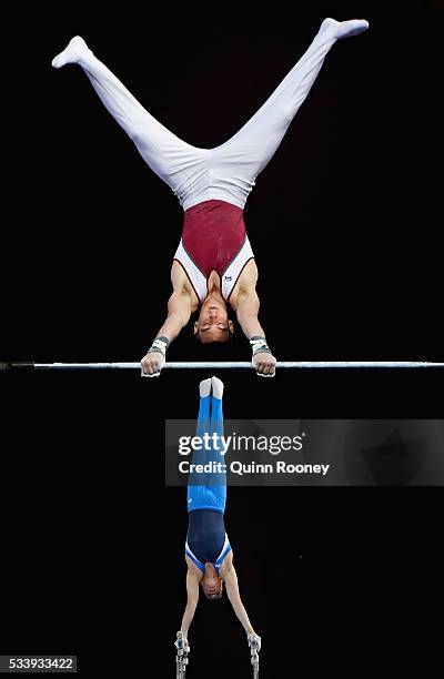 Kurt Grumelart of Queensland competes on the high bar as Alexander Waro of New South Wales competes on the parrallel bars during the 2016 Australian...