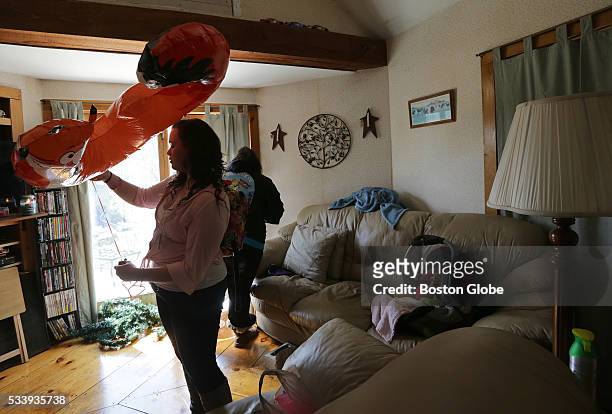 Colby Jackman and her sister Janelle Spector put up decorations for the small birthday party gathering at Spector's Newbury, Mass., home on May 9,...