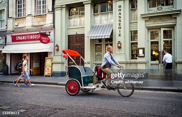 cycle rickshaw in william iv street, london - rickshaw or tuk tuk or surrey or pedicab stock pictures, royalty-free photos & images