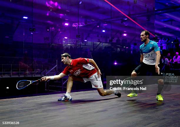 Simon Rosner of Germany competes against Gregory Gaultier of France during day one of the PSA Dubai World Series Finals 2016 at Burj Park on May 24,...