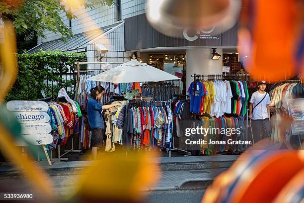 Man looking for clothes at a second hand store in Tokyo Japan.