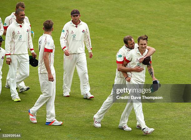 Kyle Jarvis of Lancashire and Tom Smith celebrate as they leave the field after victory against Surrey during the Specsavers County Championship...