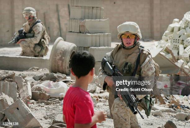 Marine LCpl. Brian Norcoss and LCpl. Joshua Wall from Golf Company 2nd Battalion 7th Marines set up security during a patrol on August 16, 2005 in...