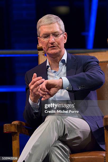 Apple CEO Tim Cook looks at his Apple watch during the kick-off of Startup Fest Europe on May 24, 2016 in Amsterdam, The Netherlands. The event...