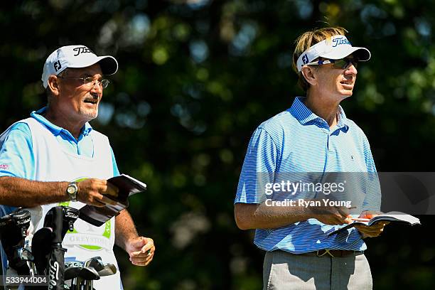 Brad Faxon checks his yardage book with his caddie during the first round of the PGA TOUR Champions Regions Tradition at Greystone Golf & Country...