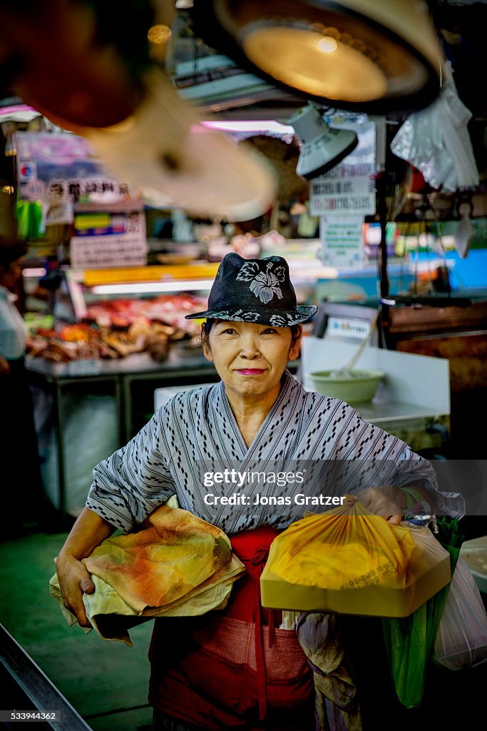 An old woman doing daily shopping at Makishi market in...