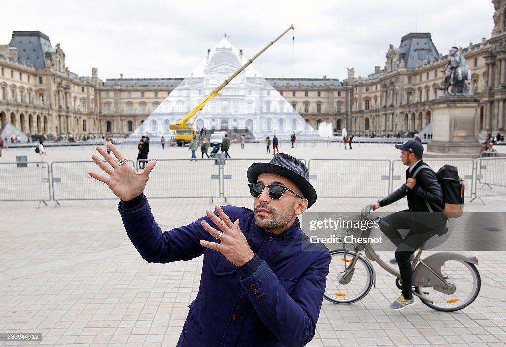 French Street Artist JR Installs A Public Artwork At The Louvre Museum In Paris