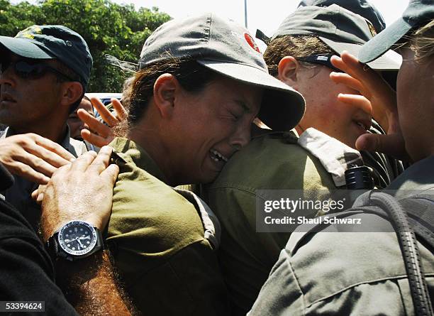 An Israeli solider cries as Israeli police clash with anti-disengagement activists trying to prevent the entry of shipping containers August 16, 2005...