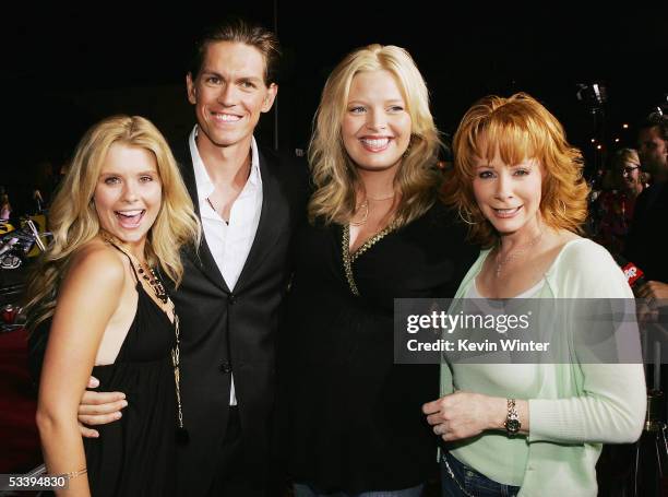 Actors Joanna Garcia, Steve Howey, Melissa Peterman and Reba McEntire pose at the premiere of Twentieth Century Fox' s "Supercross: The Movie" at the...