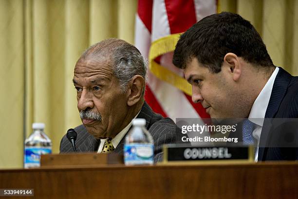 Representative John Conyers, a Democrat from Michigan and ranking member of the House Judiciary Committee, left, listens to counsel during a House...