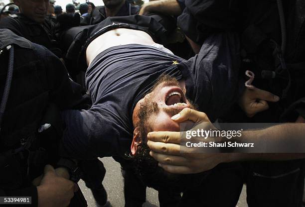 Israeli police arrest anti-disengagement activists trying to prevent the entry of shipping containers August 16, 2005 into Neve Dekalim, the largest...