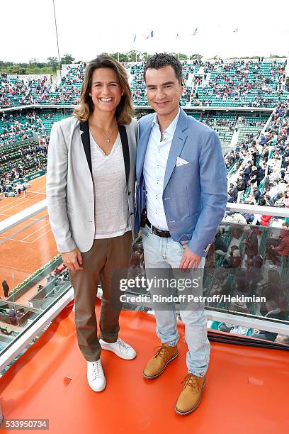 Sports journalist Laurent Luyat poses with his Co-Presenter Amelie Mauresmo at France Television french chanel studio during the 2016 French Tennis...