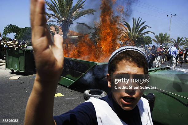 Teenage settler gestures as Israeli police clash with anti-disengagement activists trying to prevent the entry of shipping containers August 16, 2005...
