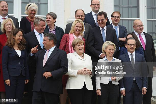 Members of the current German government, including German Chancellor Angela Merkel , arrive to pose for a group photo during a break while meeting...