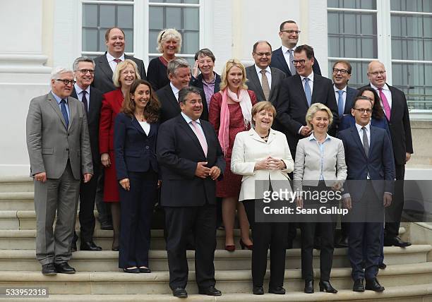Members of the current German government, including German Chancellor Angela Merkel , arrive to pose for a group photo during a break while meeting...