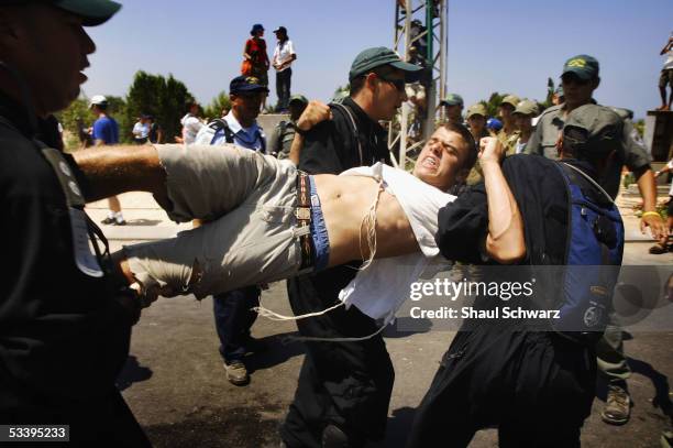 Israeli police arrest anti-disengagement activists trying to prevent the entry of shipping containers August 16, 2005 into Neve Dekalim, the largest...