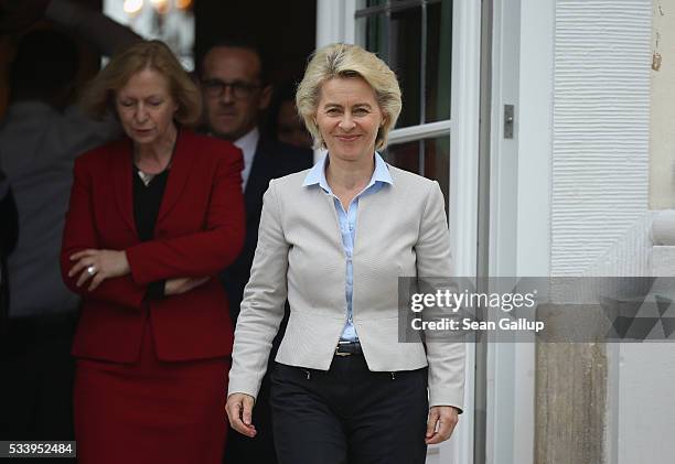Members of the current German government, including German Defense Minister Ursula von der Leyen , arrive to pose for a group photo during a break...
