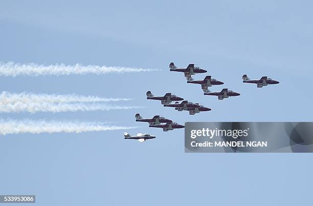 The Royal Canadian Air Force Snowbirds aerobatics team perform a fly-over above the Jefferson Memorial on May 24, 2016 in Washington, DC. / AFP /...