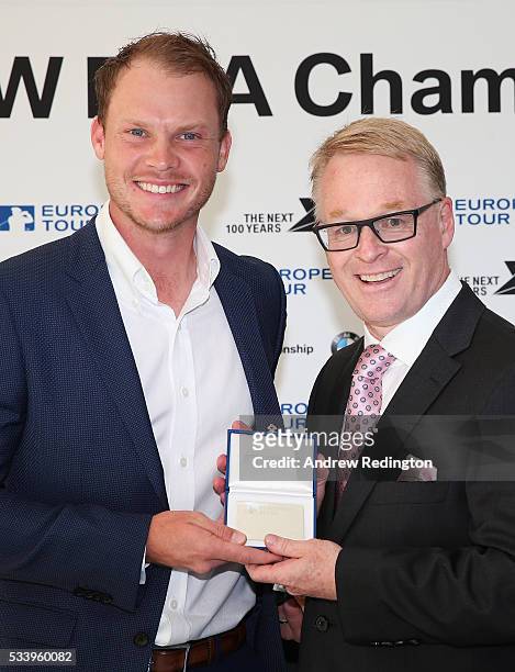 Masters Champion Danny Willett of England receives European Tour Honorary Life Membership from The European Tour Chief Executive Keith Pelley during...