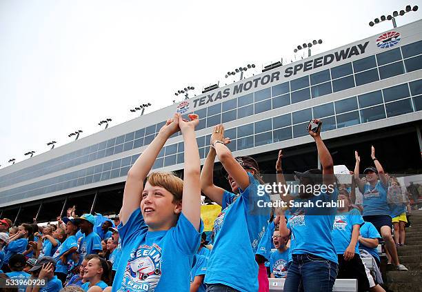 Students and faculty cheer during the Speeding To Read Championship Assembly at Texas Motor Speedway on May 24, 2016 in Fort Worth, Texas.
