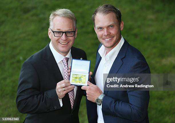 Masters Champion Danny Willett of England receives European Tour Honorary Life Membership from The European Tour Chief Executive Keith Pelley during...