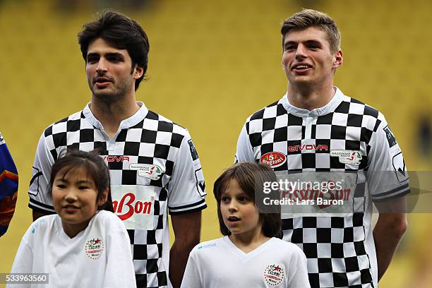 Carlos Sainz of Spain and Scuderia Toro Rosso and Max Verstappen of Netherlands and Red Bull Racing line up for the match during the 24th World Stars...