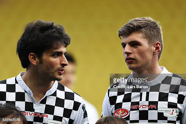 Carlos Sainz of Spain and Scuderia Toro Rosso and Max Verstappen of Netherlands and Red Bull Racing line up for the match during the 24th World Stars...