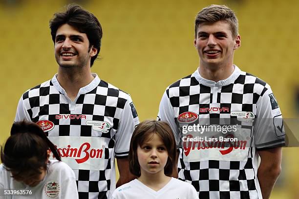 Carlos Sainz of Spain and Scuderia Toro Rosso and Max Verstappen of Netherlands and Red Bull Racing line up for the match during the 24th World Stars...