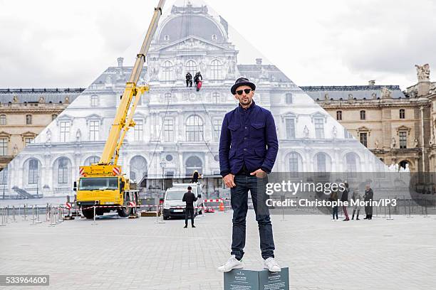 French street artist JR poses for a photo outside The Louvre on May 24, 2016 in Paris, France. The artist has covered The Louvre Pyramid by an...