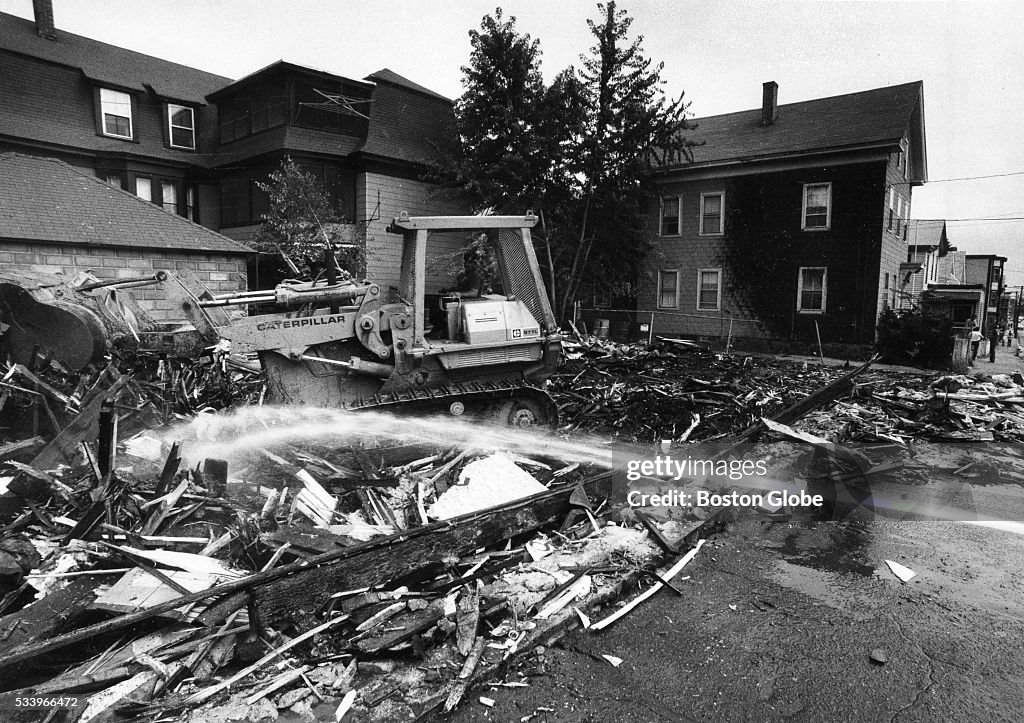 Lawrence Riots A bulldozer clears debris as the fire department pours water on the ...